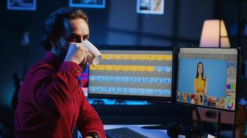 Portrait of happy photo editor color correcting photographs in creative studio while enjoying cup of coffee. Smiling photographer selecting best pictures for editorial content