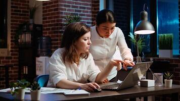 Employee asking for help from coworker after being stuck on difficult project task. Worker in brick wall office requesting assistance from knowledgeable colleague, writing email to business partner photo