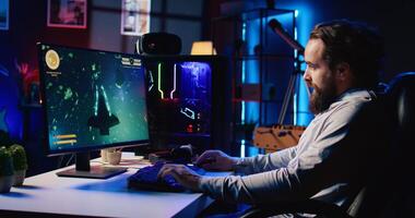 Man broadcasting gaming session online, talking with audience while destroying enemies to finish level in flying game. Gamer streaming live SF videogame, shooting asteroids and chatting with fans photo
