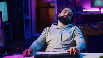 Streamer doing charitable marathon during live broadcast, struggling to remain awake while playing videogames. Gamer trying to not fall asleep doing livestream with viewers all day photo