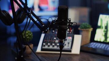 Close up shot of professional microphone used to produce quality internet show for online livestreaming channel. Streaming sound capturing and recording podcasting tool in empty living room photo