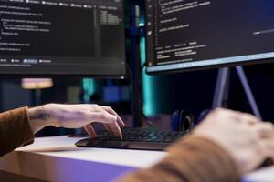 Developer typing code on computer to futureproof company network from downtimes and unexpected system failures. Man deploying programming script increasing data security, close up shot photo