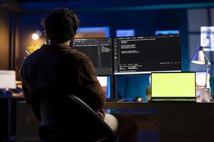 Programmer designing and developing software applications using isolated screen laptop. IT professional implementing and maintaining company systems using mockup notebook photo
