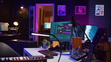 Electronic instruments used for mixing and recording tunes in empty home studio, soundboard controls and mastering console used to create songs. Creative space with amplifier and equalizer. Camera B. photo