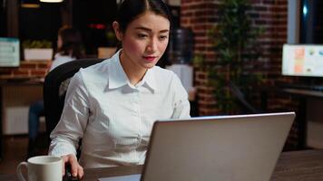 Employee writing important emails at computer desk, finalizing deal with business associates. Businesswoman doing b2b networking over internet with prospecting clients, typing on laptop photo