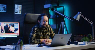 Man in call session with therapist, asking for advice, feeling down. Remotely working employee in online consultation with psychologist from stylish cozy home, greeting him, camera B photo