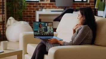 Remote worker talks with board of directors during videocall business meeting from home office. Teleworker speaks in remote videoconference telework call, receiving feedback from management photo