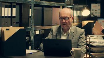 Senior inspector identifying patterns in criminal behavior by analyzing classified files and legal documents. Private detective looking at forensic evidence in hope on finding clues. Camera A. photo