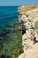 Steep karst limestone shores and rocks in the Dzhangul tract, western Crimea, Tarkhankut photo
