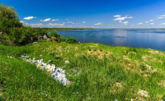 Environmental problem, pollution of the shores of a reservoir with construction and plastic waste, Khadzhibey estuary photo
