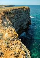 Steep karst limestone shores and rocks in the Dzhangul tract, western Crimea, Tarkhankut photo