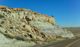 The Painted Desert on a sunny day. Diverse sedimentary rocks and clay washed out by water. Petrified Forest National Park, USA, Arizona photo