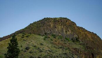 Mountain formations from vertical columnar lava formations, USA photo