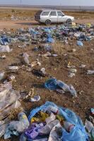 UKRAINE, CRIMEA - AUGUST 10, 2007 Pollution of the steppe nature with plastic household waste photo