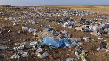 UKRAINE, CRIMEA - AUGUST 10, 2007 Pollution of the steppe nature with plastic household waste photo