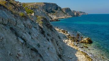 View of the steep banks and rocks in the water in the Dzhangul tract, western Crimea photo
