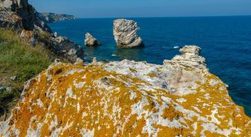 View of the steep banks and rocks in the water in the Dzhangul tract, western Crimea photo