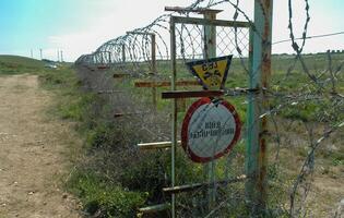 Barbed wire fence at Cape Priboyny in the Dzhangul region in the western Crimea, Tarkhankut photo