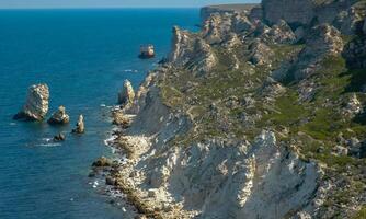 View of the steep banks and rocks in the water in the Dzhangul tract, western Crimea photo