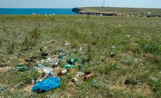 UKRAINE, CRIMEA - AUGUST 02, 2009 Pollution of the steppe nature with plastic household waste photo