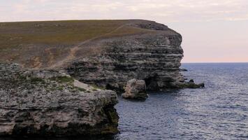 Steep rocky coast of Pontic limestones in eastern Crimea photo