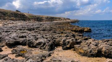 Flat rocky shore with many littoral puddles rich in life, in the eastern Crimea, Black Sea photo