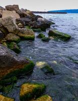 Shore protection structures near the jetty made of large stones in Varna, Bulgaria photo
