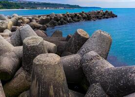 coast protection structures, pier and concrete tetrahedrons for storm protection photo