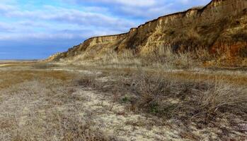 Steep clay bank of the Tiligul estuary in winter photo