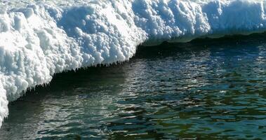 Frozen Black Sea, blocks of melting ice on the seashore photo