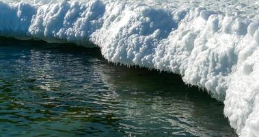 Frozen Black Sea, blocks of melting ice on the seashore photo