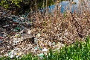 Plastic garbage on the shore in Hadzhibeysky estuary. Eutrophication of the reservoir, the problem of ecology photo