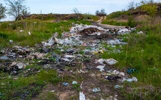 Heaps of plastic trash on the shore of the reservoir. Ecology of nature photo