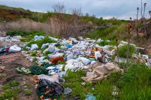 Heaps of plastic trash on the shore of the reservoir. Ecology of nature photo