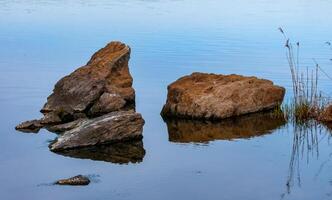 Coast with rocks in the water, Hadzhibey estuary. Reflection in water photo