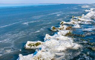 Ice floating near the shore and ice floes on the shore in the Tiligul estuary in winter, Ukraine photo