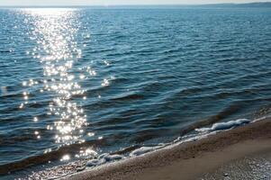 Sun glare on the water near the sandy spit in Tiligul estuary, Ukraine photo