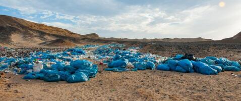 Plastic bottles and various garbage from hotels in the wild, Garbage dump in the desert in Egypt photo