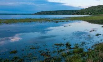Summer landscape, reflection of clouds on shallow water in flat water Tiligul estuary, Ukraine photo