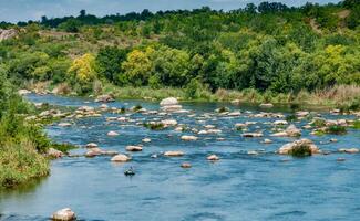 A fisherman in a rubber boat catches fish behind rock rifts in the middle photo