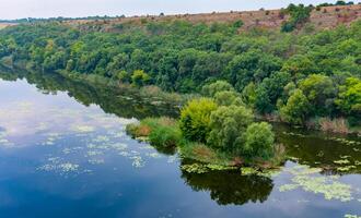Old floodplain forest along the banks of the Southern Bug River in a granite canyon photo