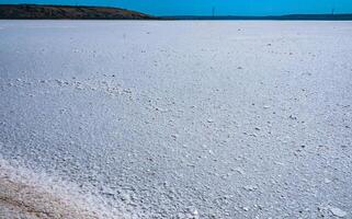 Self-precipitating table salt sodium chloride on the surface of a dried-up reservoir - Kuyalnik estuary, Odessa region, Ukraine photo