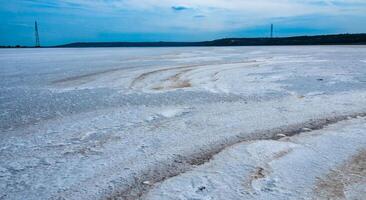 Self-precipitating table salt sodium chloride on the surface of a dried-up reservoir photo