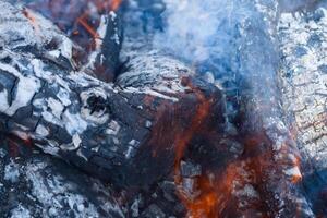 Firewood burning in the brazier, smoldering log coals photo
