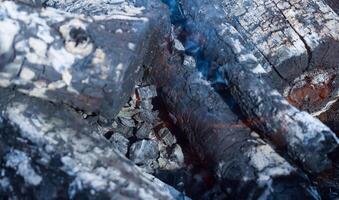 Firewood burning in the brazier, smoldering log coals photo