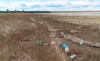 Heaps of garbage on the bank of the Kuyalnik estuary photo