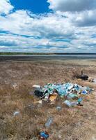 Heaps of garbage on the bank of the Kuyalnik estuary photo