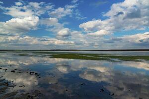 Reflection of white storm clouds in the water of the Tiligul estuary, Ukraine photo