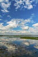 Reflection of white storm clouds in the water of the Tiligul estuary, Ukraine photo