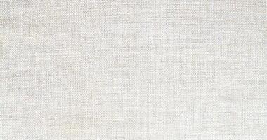 Natural Linen Material Textile Canvas Fabric Texture Background Close-up Detail of Fabric Natural Color Hemp Material Pattern Design Wallpaper. Can be Used as Background or For Graphic Design photo
